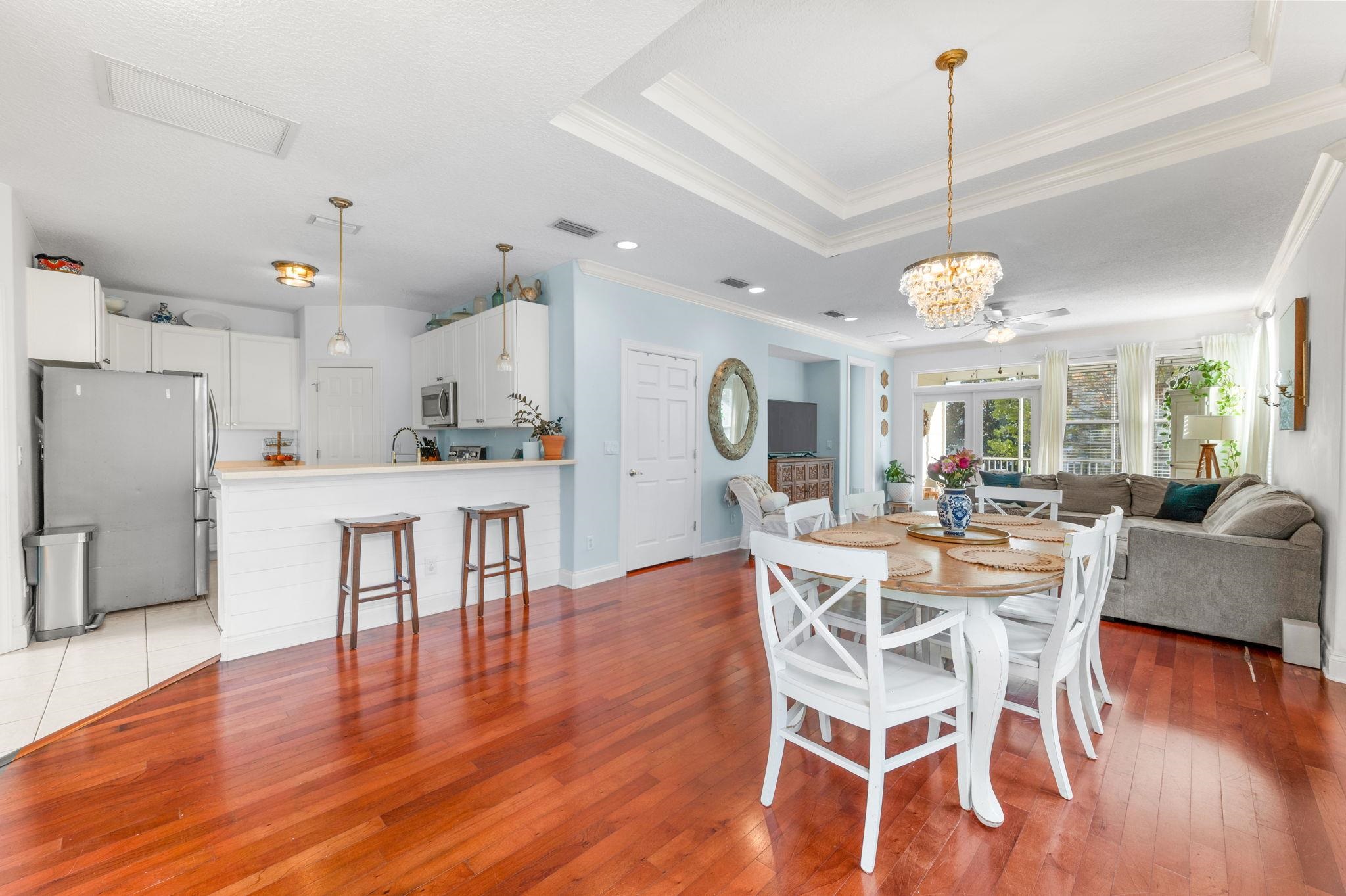178 Sunset Circle North St. Augustine, FL 32080 - Photo 4 of 45 a view of a dining room and livingroom with furniture wooden floor a chandelier