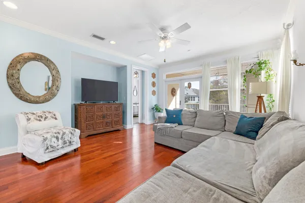 a living room with furniture and wooden floor