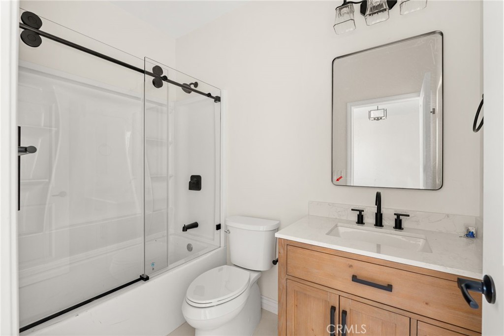3260 Howe Street Corona, CA 92881 - Photo 16 of 28 a bathroom with a sink a toilet and shower