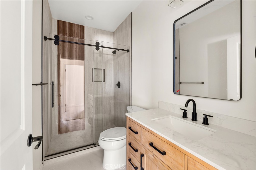 3260 Howe Street Corona, CA 92881 - Photo 18 of 28 a bathroom with a sink a toilet and shower