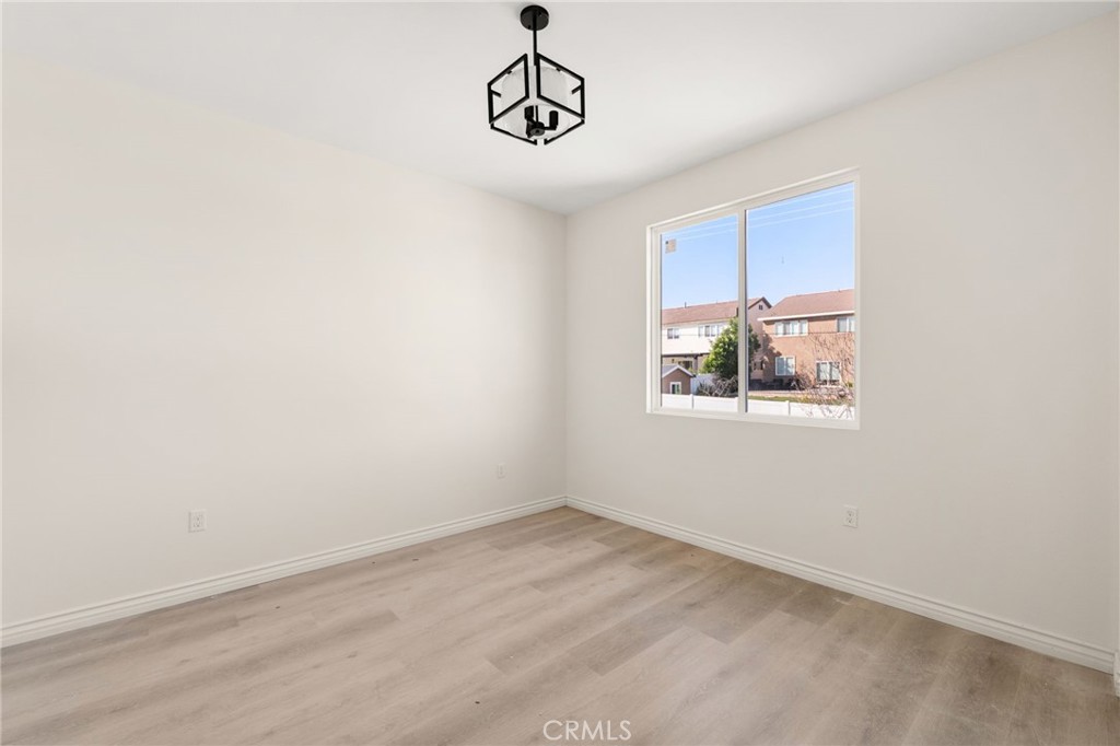 3260 Howe Street Corona, CA 92881 - Photo 19 of 28 an empty room with windows and ceiling fan