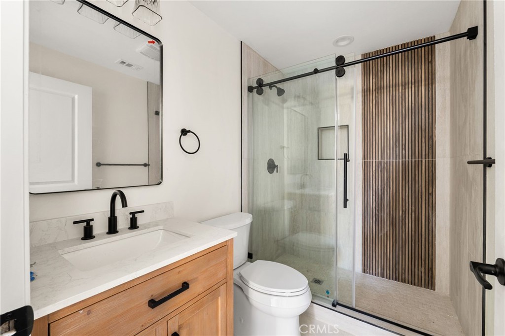 3260 Howe Street Corona, CA 92881 - Photo 20 of 28 a bathroom with a shower sink vanity mirror and toilet