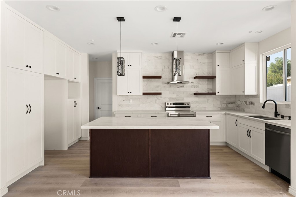 3260 Howe Street Corona, CA 92881 - Photo 4 of 28 a kitchen with kitchen island sink stove and refrigerator