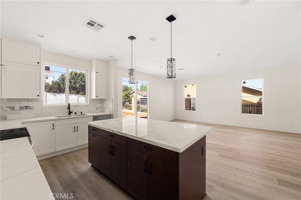 3260 Howe Street Corona, CA 92881 - Photo 7 of 28 a kitchen with center island and sink