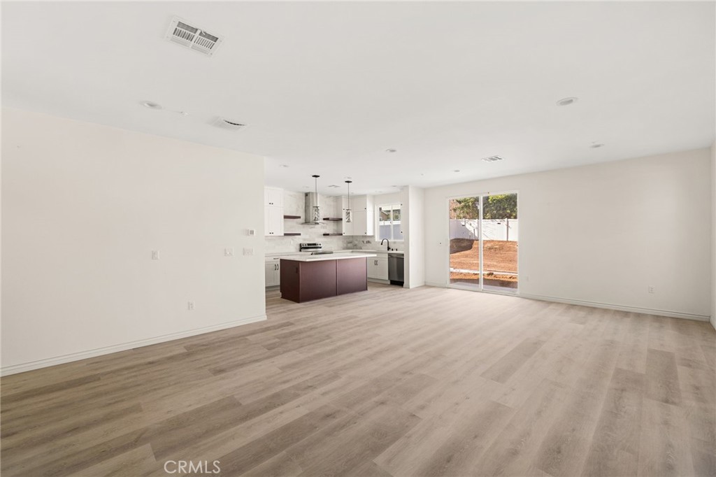 3260 Howe Street Corona, CA 92881 - Photo 8 of 28 a view of a kitchen with a sink and a refrigerator