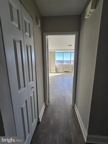 a view of a hallway with wooden floor