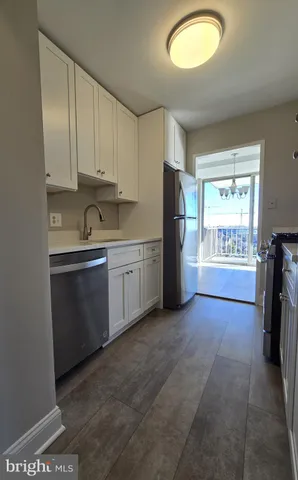 a kitchen with cabinets and window