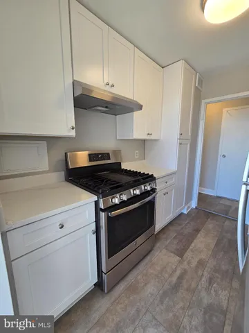 a stove top oven sitting inside of a kitchen