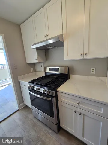 a stove top oven sitting inside of a kitchen