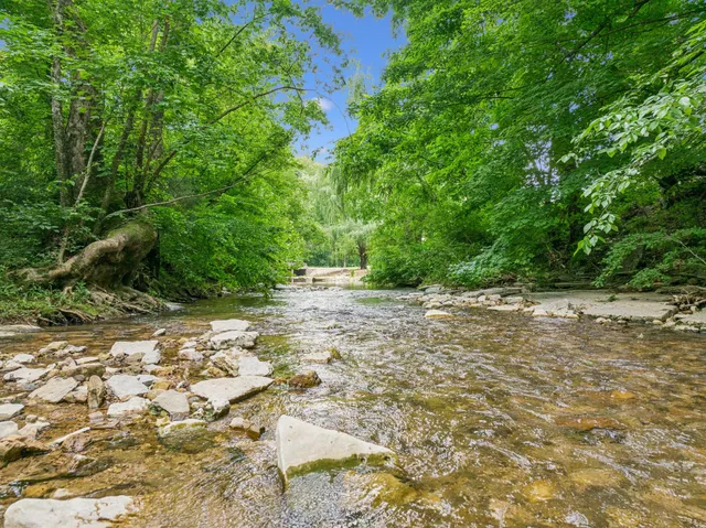 a view of backyard with deck and outdoor seating