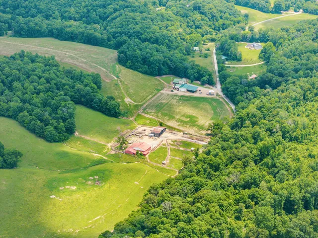 a backyard of a house with a yard and outdoor seating