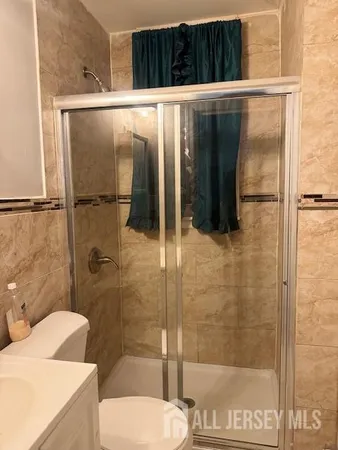 a bathroom with a toilet and a shower