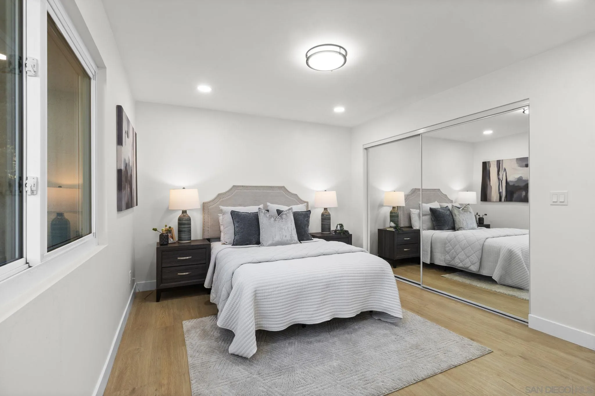 9408 Avenida Acero Spring Valley, CA 91977 - Photo 2 of 2 a bedroom with a bed and a large mirror
