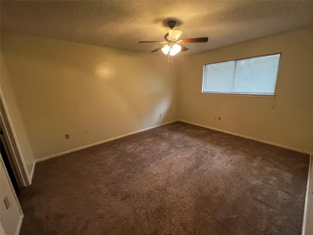 a view of a room with a chandelier fan