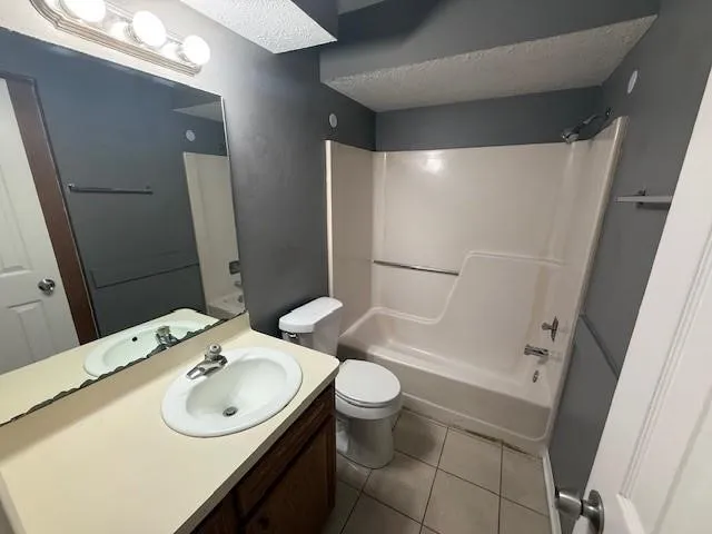 a bathroom with a sink and mirror with toilet