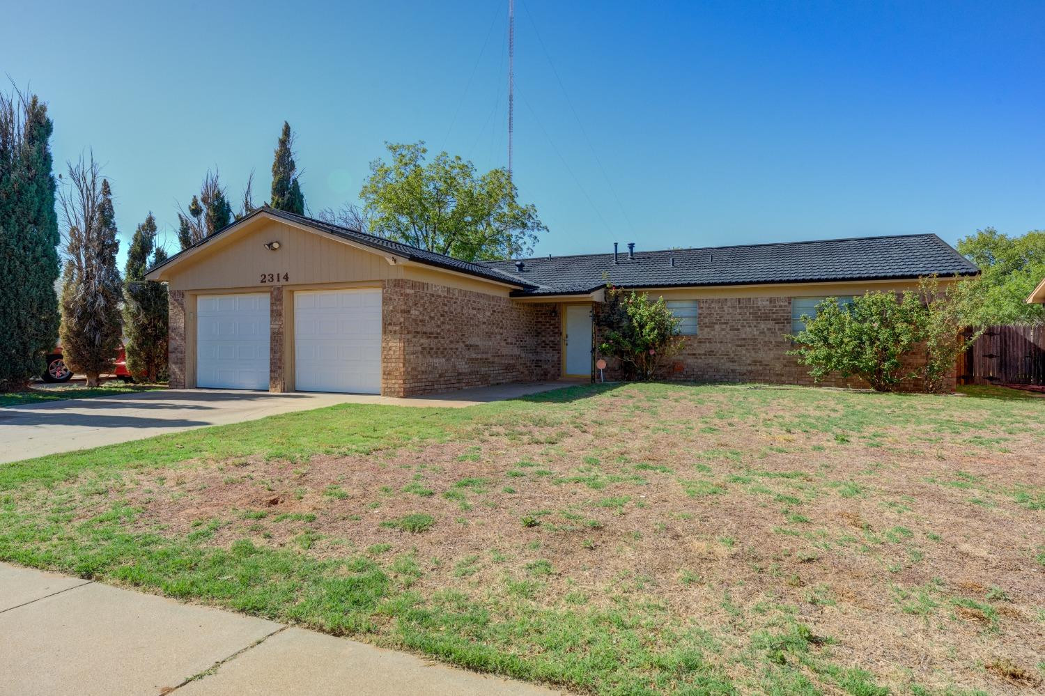 2314 79th Street Lubbock, TX 79423 - Photo 1 of 33 a front view of a house with a yard