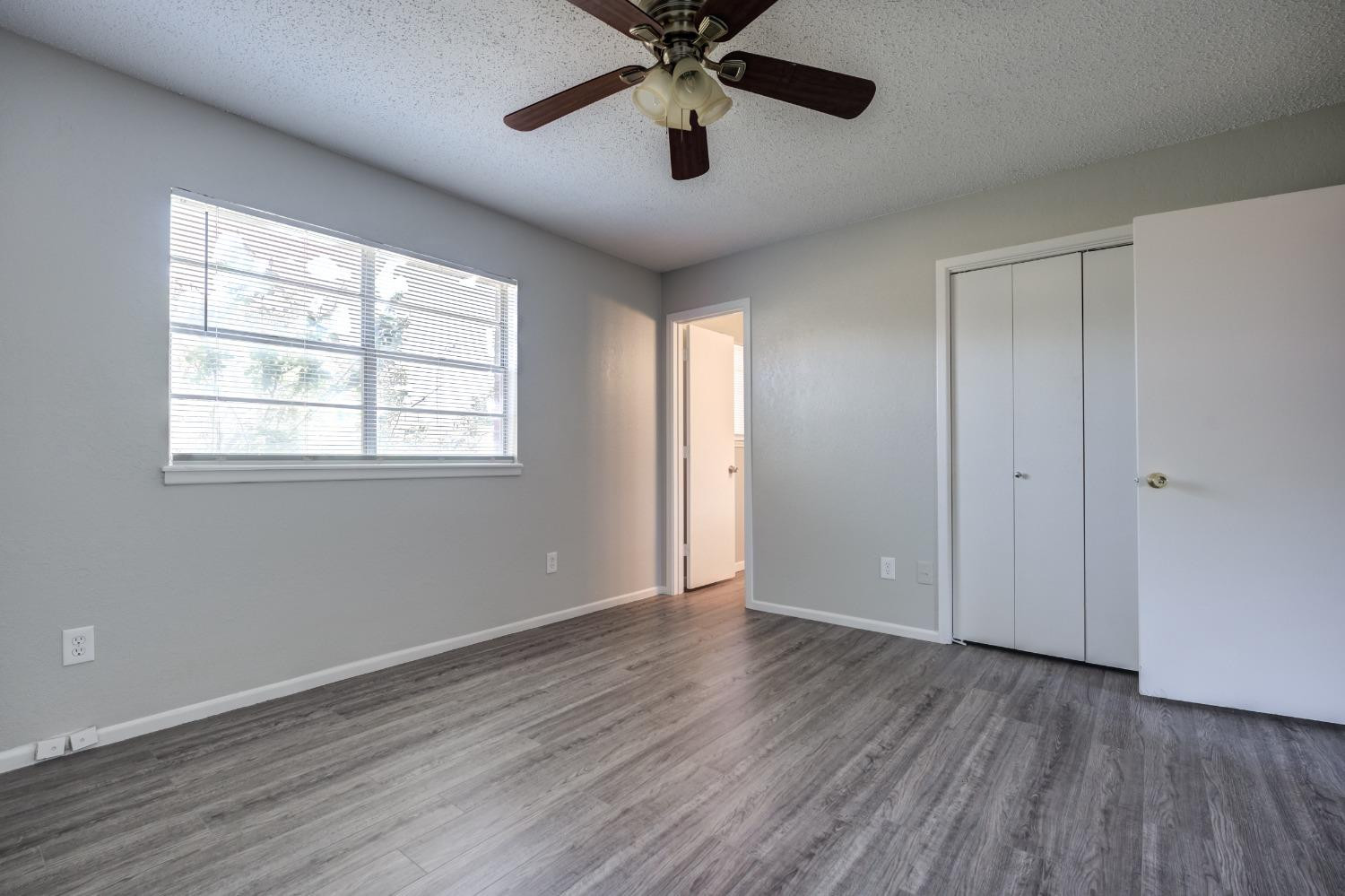 2314 79th Street Lubbock, TX 79423 - Photo 11 of 33 a view of an empty room with window and wooden floor