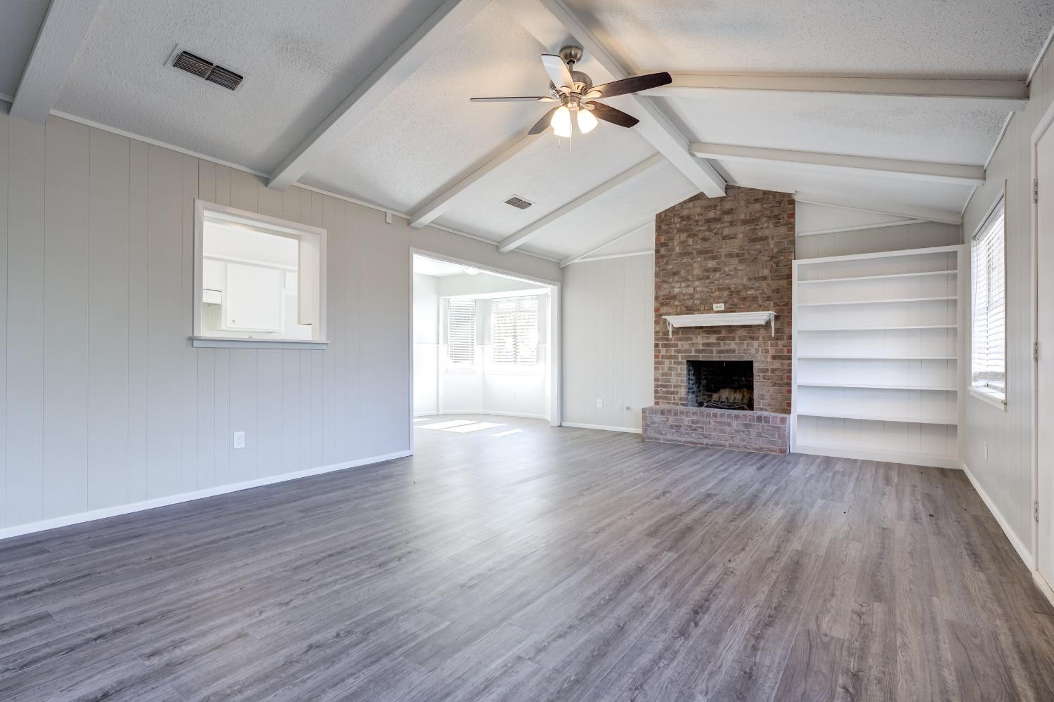 2314 79th Street Lubbock, TX 79423 - Photo 16 of 33 wooden floor in an empty room with a window