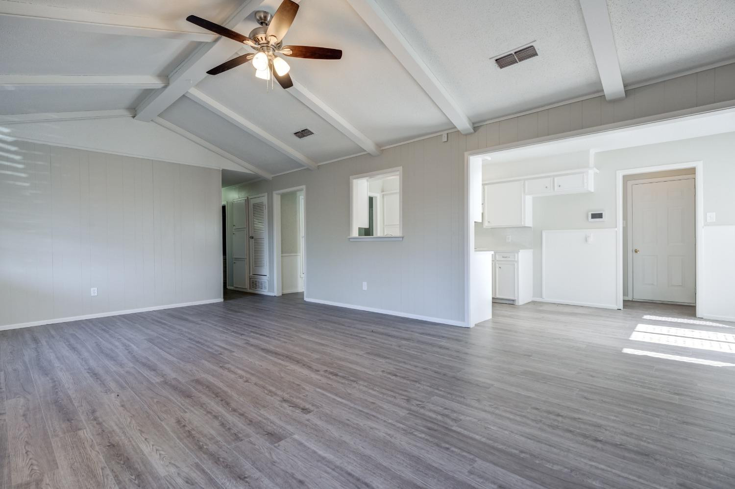 2314 79th Street Lubbock, TX 79423 - Photo 18 of 33 a view of an empty room with window and wooden floor