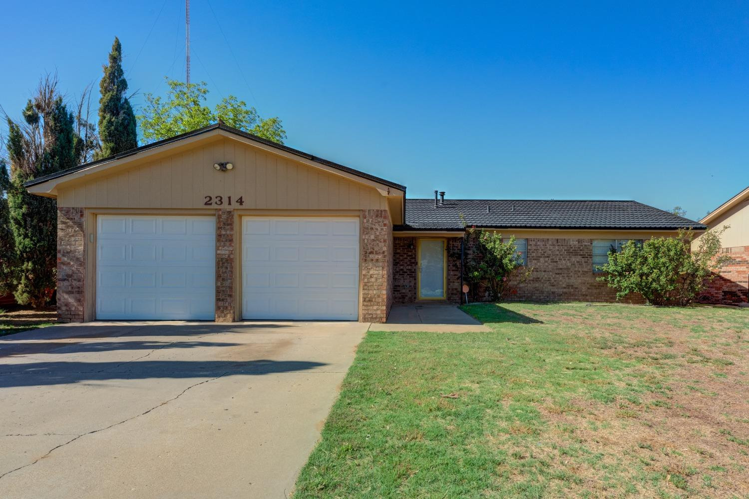 2314 79th Street Lubbock, TX 79423 - Photo 2 of 33 a front view of a house with garden