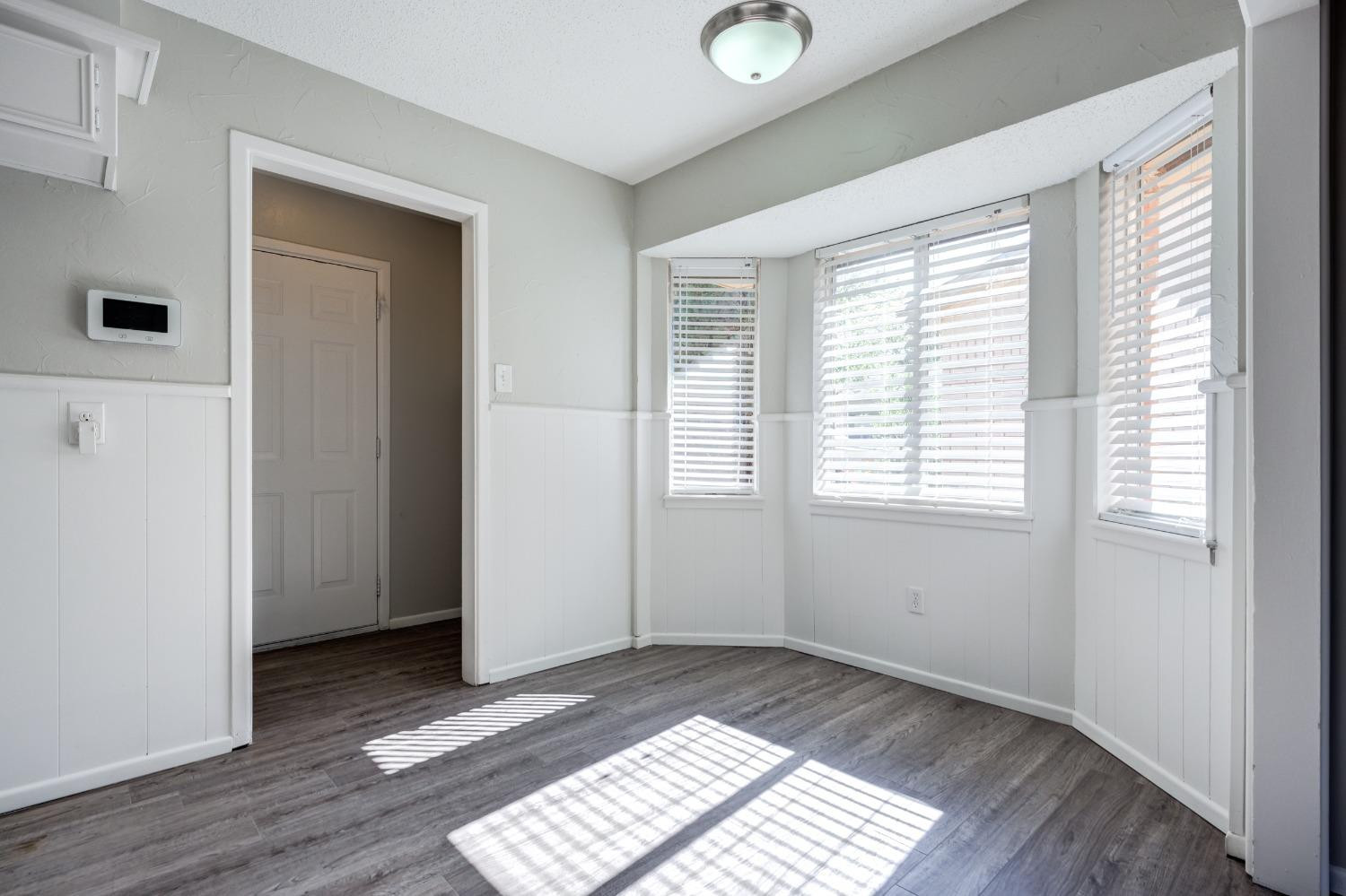 2314 79th Street Lubbock, TX 79423 - Photo 21 of 33 a view of an empty room with wooden floor and a window