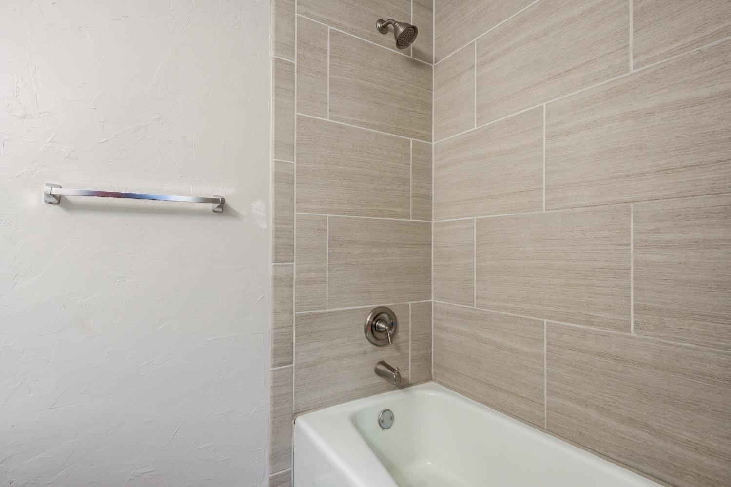 2314 79th Street Lubbock, TX 79423 - Photo 5 of 33 a bathroom with a bathtub