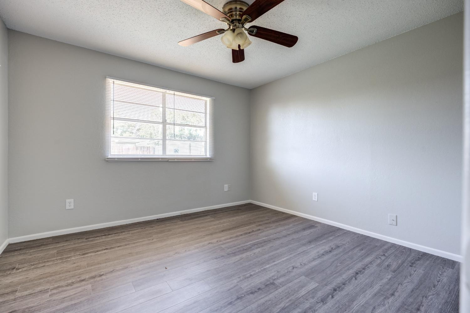 2314 79th Street Lubbock, TX 79423 - Photo 8 of 33 wooden floor in an empty room with a window