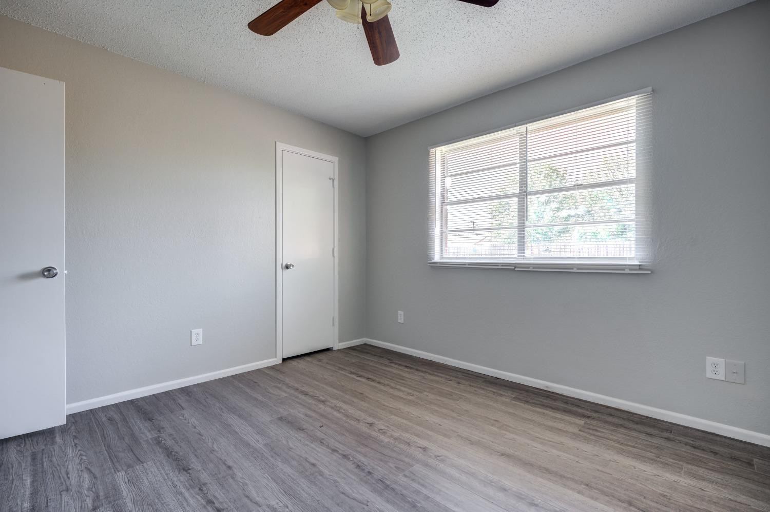2314 79th Street Lubbock, TX 79423 - Photo 9 of 33 an empty room with ceiling fan and windows