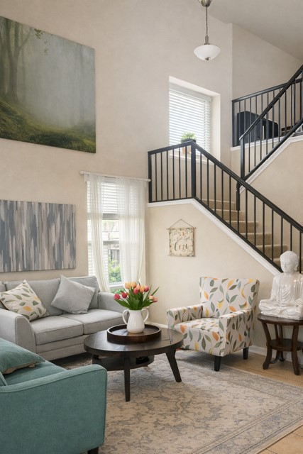 11613 Reading Court Austin, TX 78717 - Photo 4 of 20 Living space featuring a two-story ceiling, abundant natural light from multiple windows, and a staircase with black metal railings