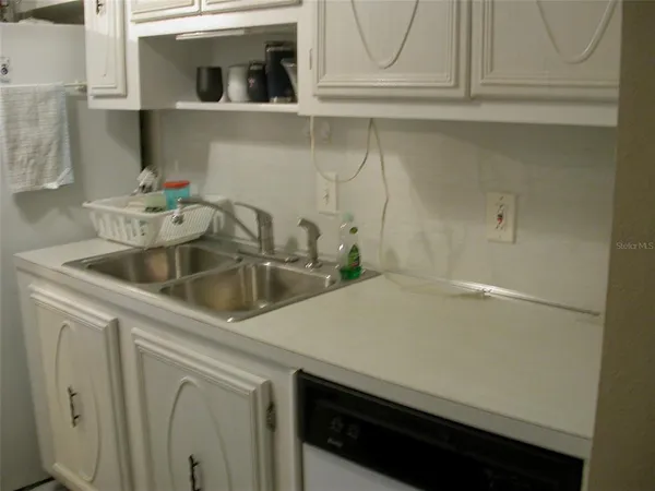 a kitchen with a sink and cabinets