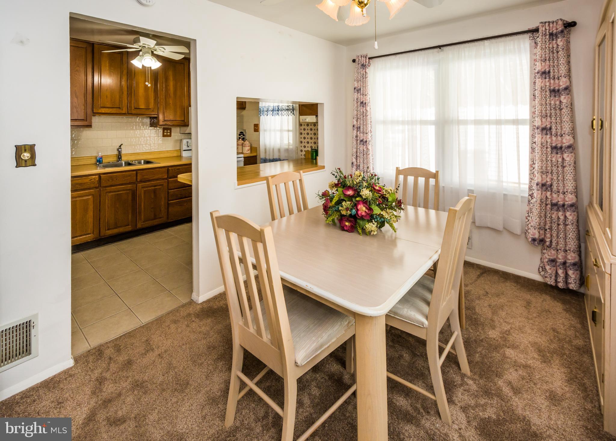 2137 Sunnythorn Road Baltimore, MD 21220 - Photo 11 of 34 a view of a dining room with furniture and a window