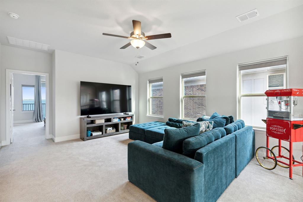 18142 Lakefront Court Forney, TX 75126 - Photo 13 of 26 a living room with furniture and a flat screen tv