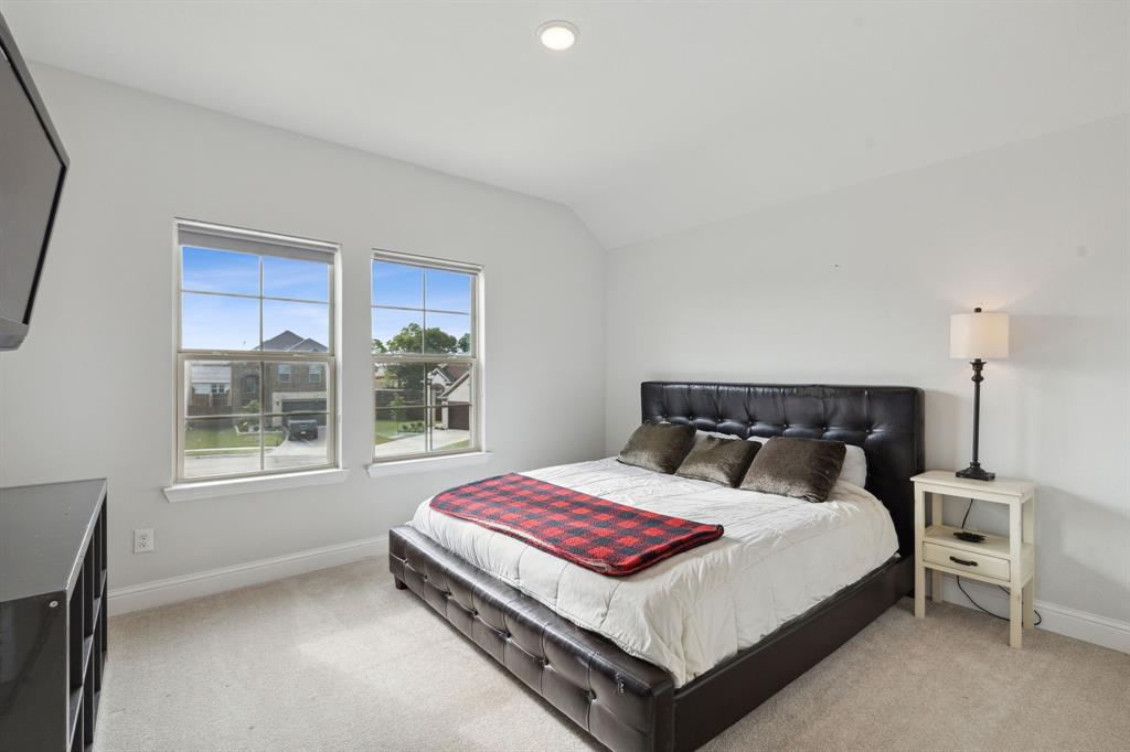 18142 Lakefront Court Forney, TX 75126 - Photo 16 of 26 a bedroom with a bed lamp and window