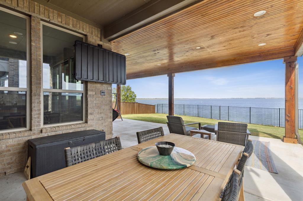 18142 Lakefront Court Forney, TX 75126 - Photo 25 of 26 a bedroom with a bed and large windows