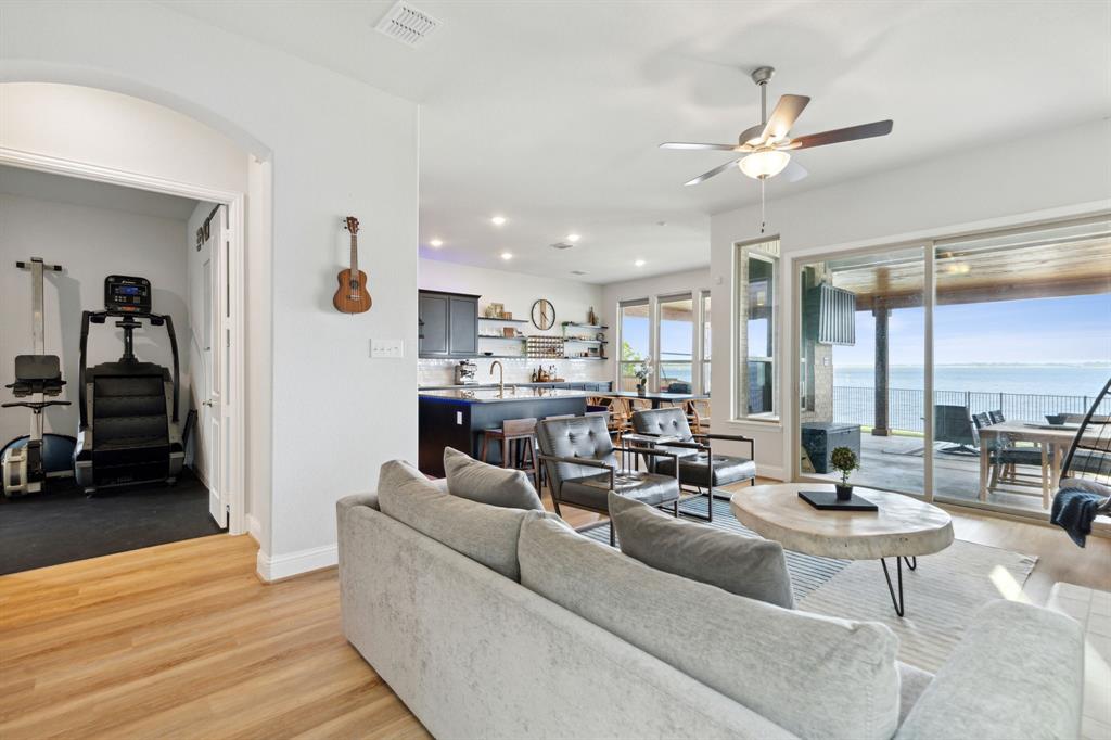18142 Lakefront Court Forney, TX 75126 - Photo 4 of 26 a living room with fireplace furniture and a view of kitchen