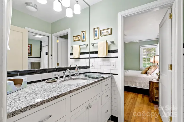 a view of staircase with white walls and a rug