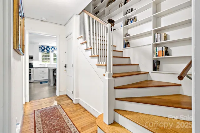 a bedroom with two beds and wooden floor