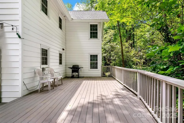 a view of a deck with furniture and a yard