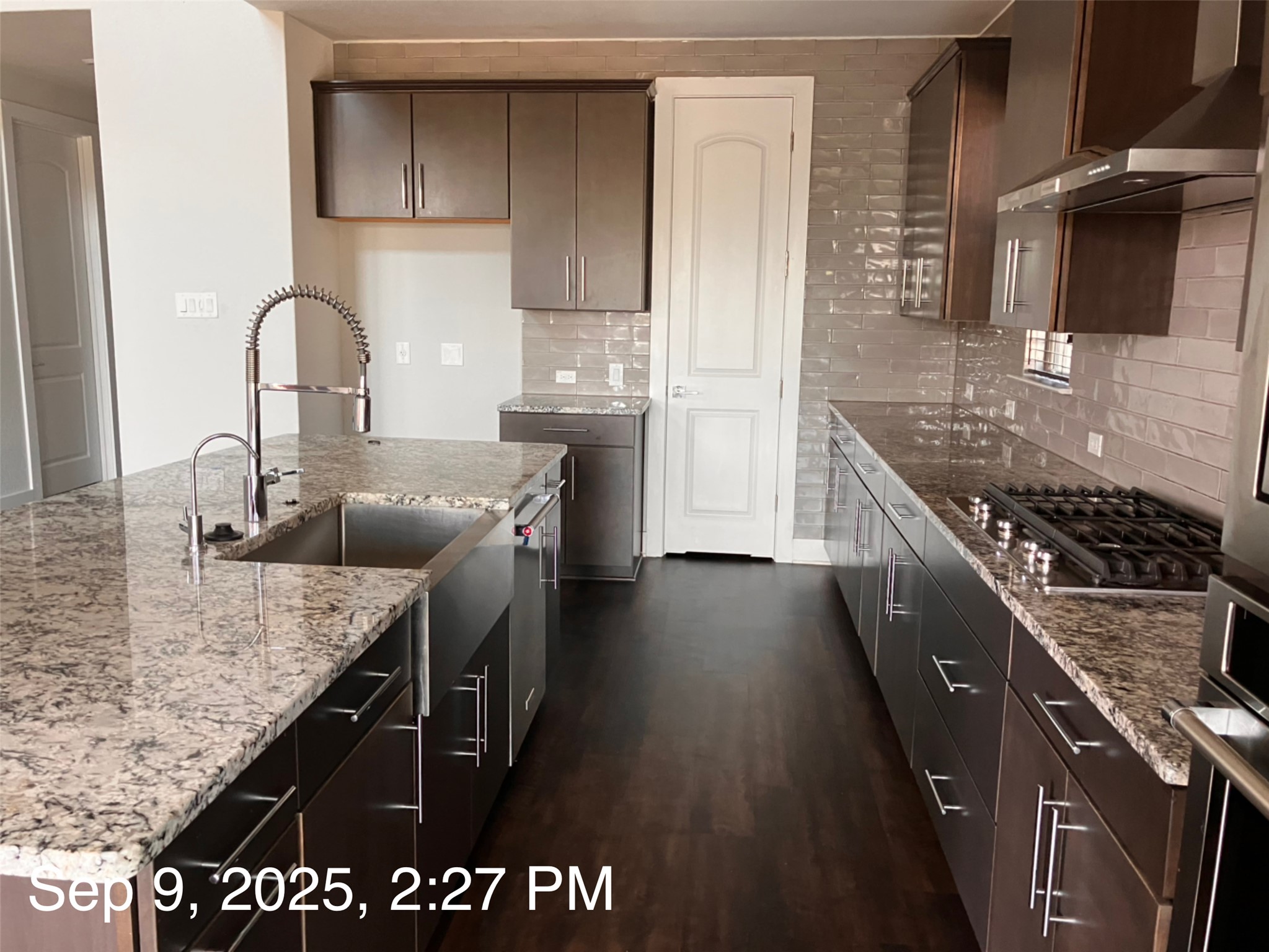 1104 Round Mountain Pass Georgetown, TX 78628 - Photo 6 of 12 a kitchen with granite countertop a sink a stove and refrigerator
