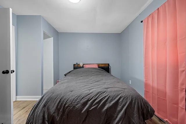 a bedroom with a bed and curtain