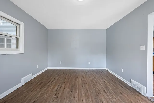 a view of a room with wooden floors and led lights
