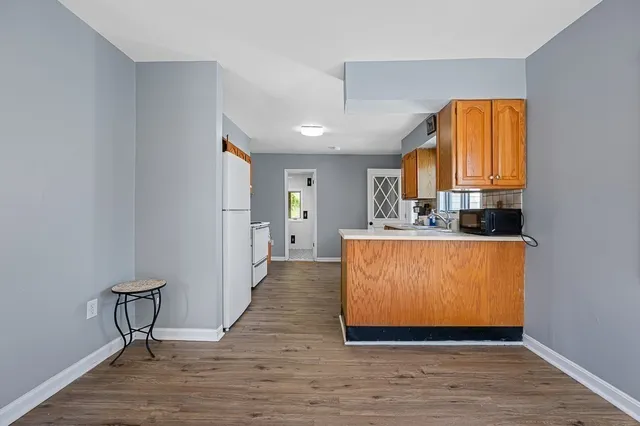 a view of kitchen with furniture and wooden floor