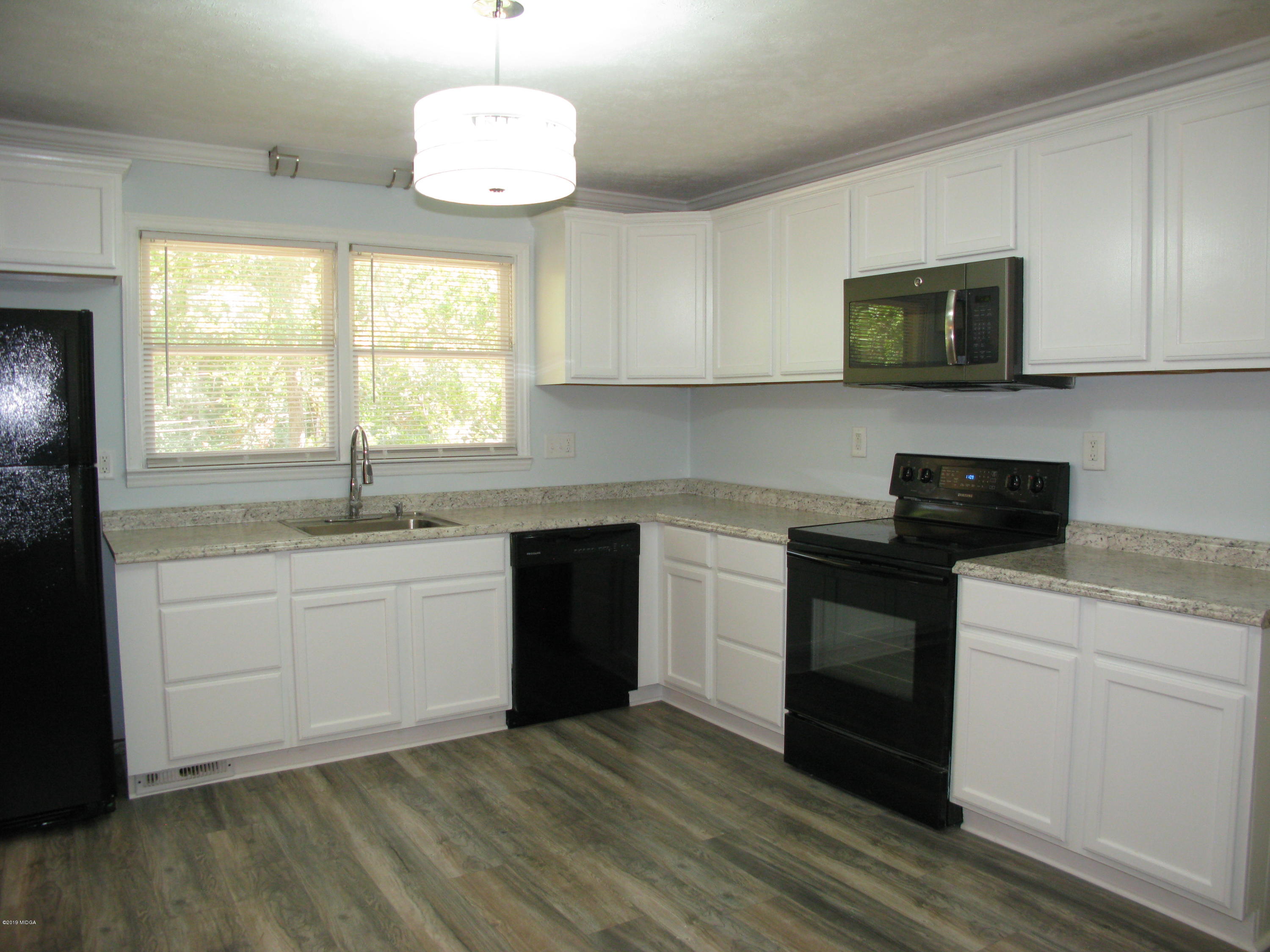 3812 Western Way Macon, GA 31216 - Photo 2 of 29 a kitchen with a sink stove and microwave