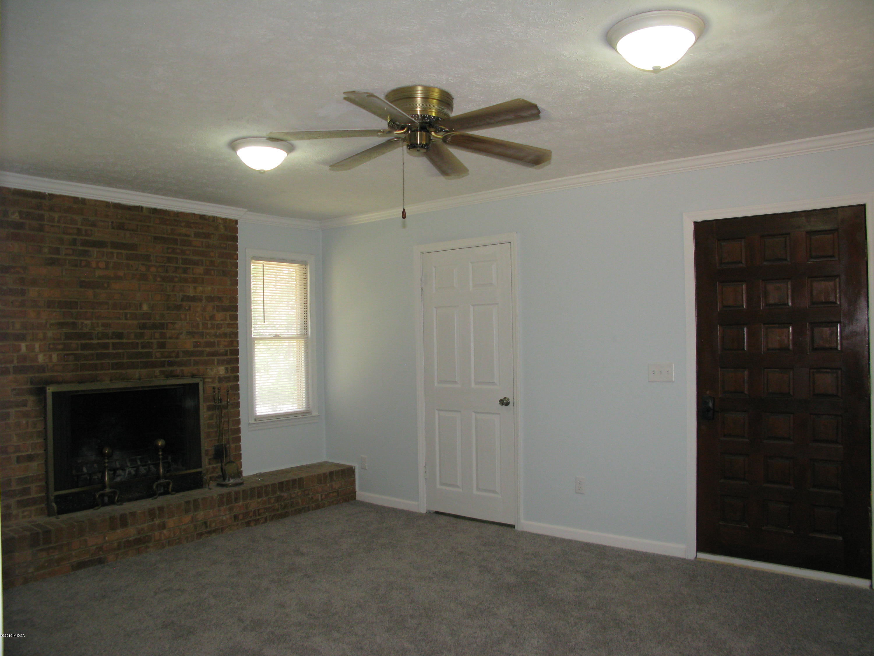 3812 Western Way Macon, GA 31216 - Photo 12 of 29 an empty room with windows and fireplace