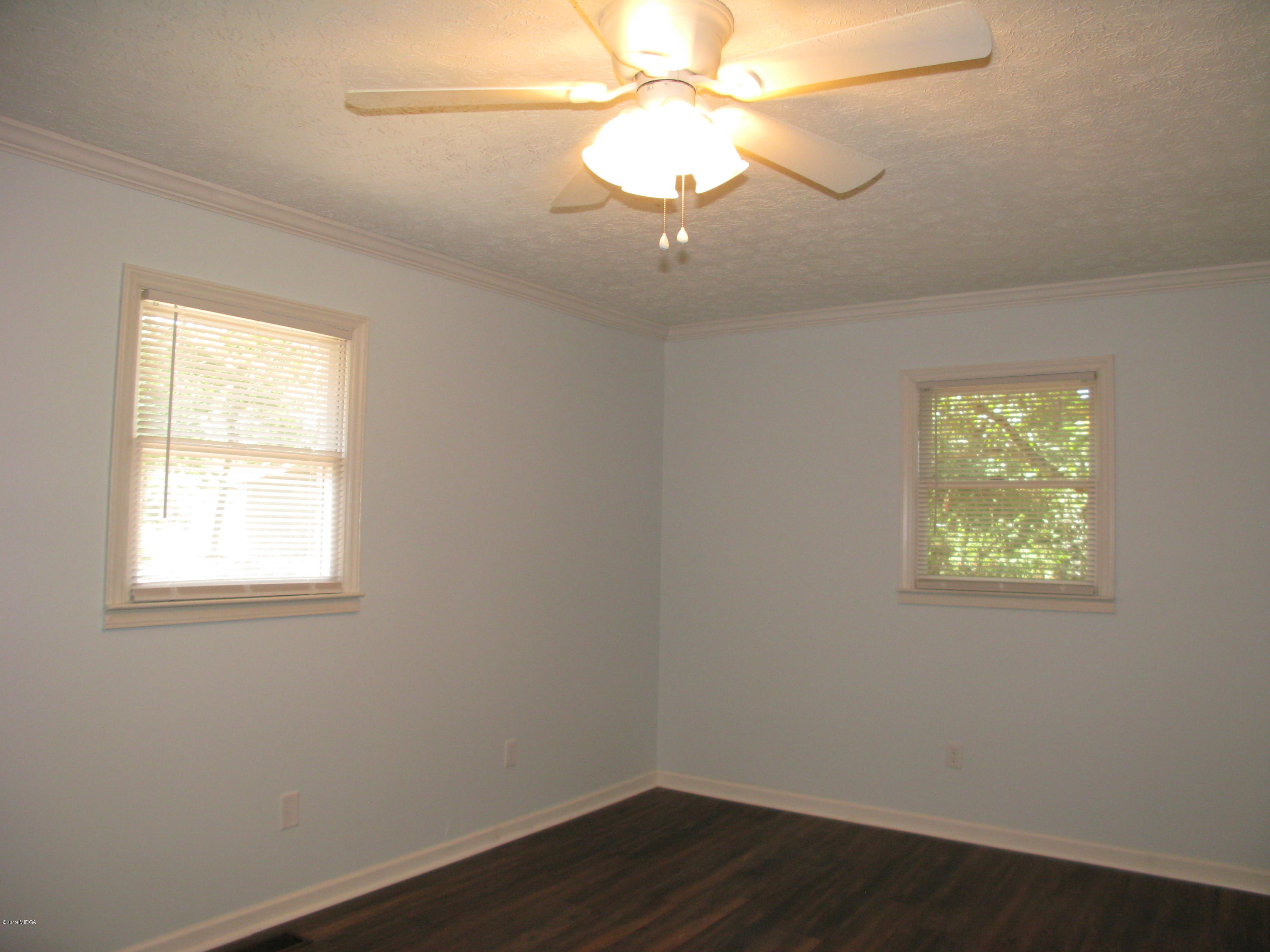 3812 Western Way Macon, GA 31216 - Photo 15 of 29 an empty room with wooden floor and windows
