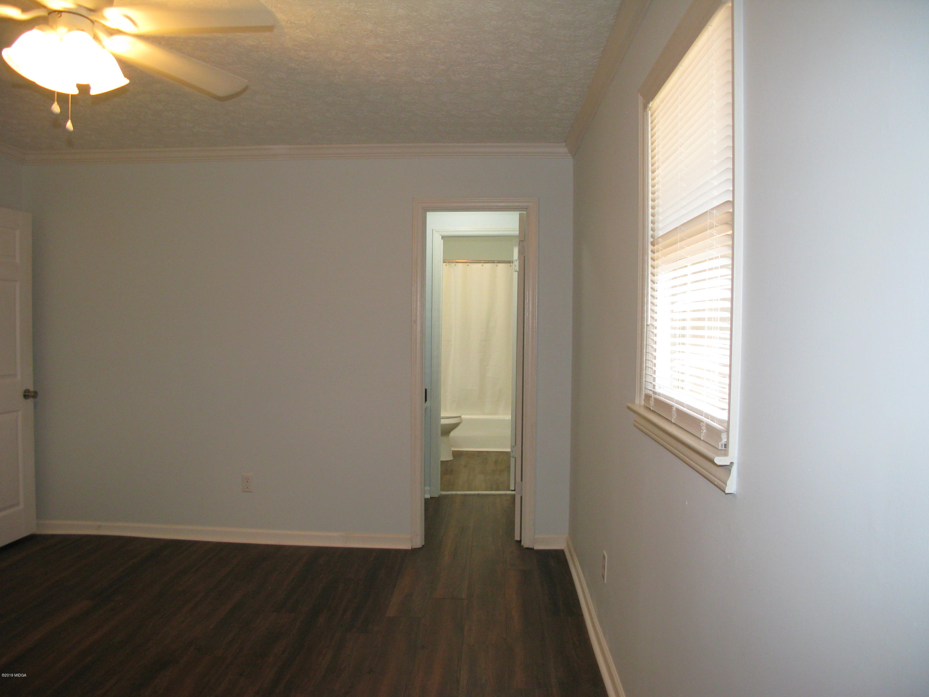 3812 Western Way Macon, GA 31216 - Photo 17 of 29 a view of an empty room with wooden floor and a window