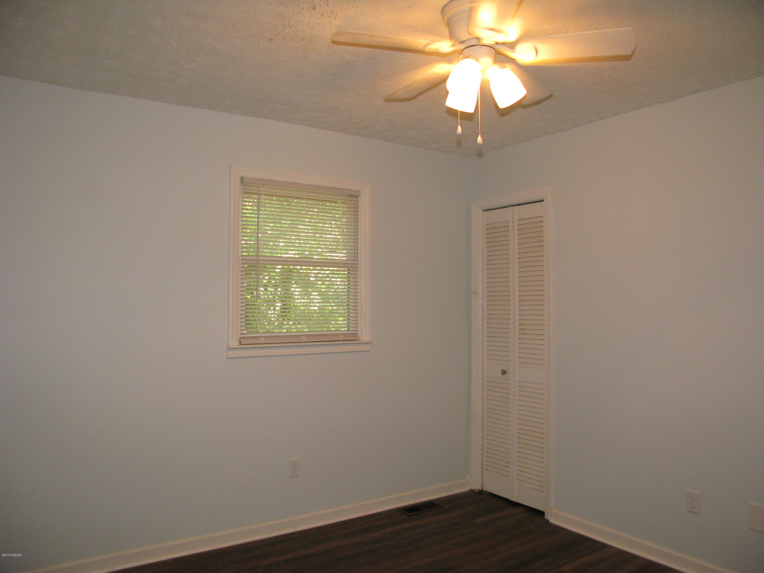 3812 Western Way Macon, GA 31216 - Photo 23 of 29 wooden floor in an empty room with a window