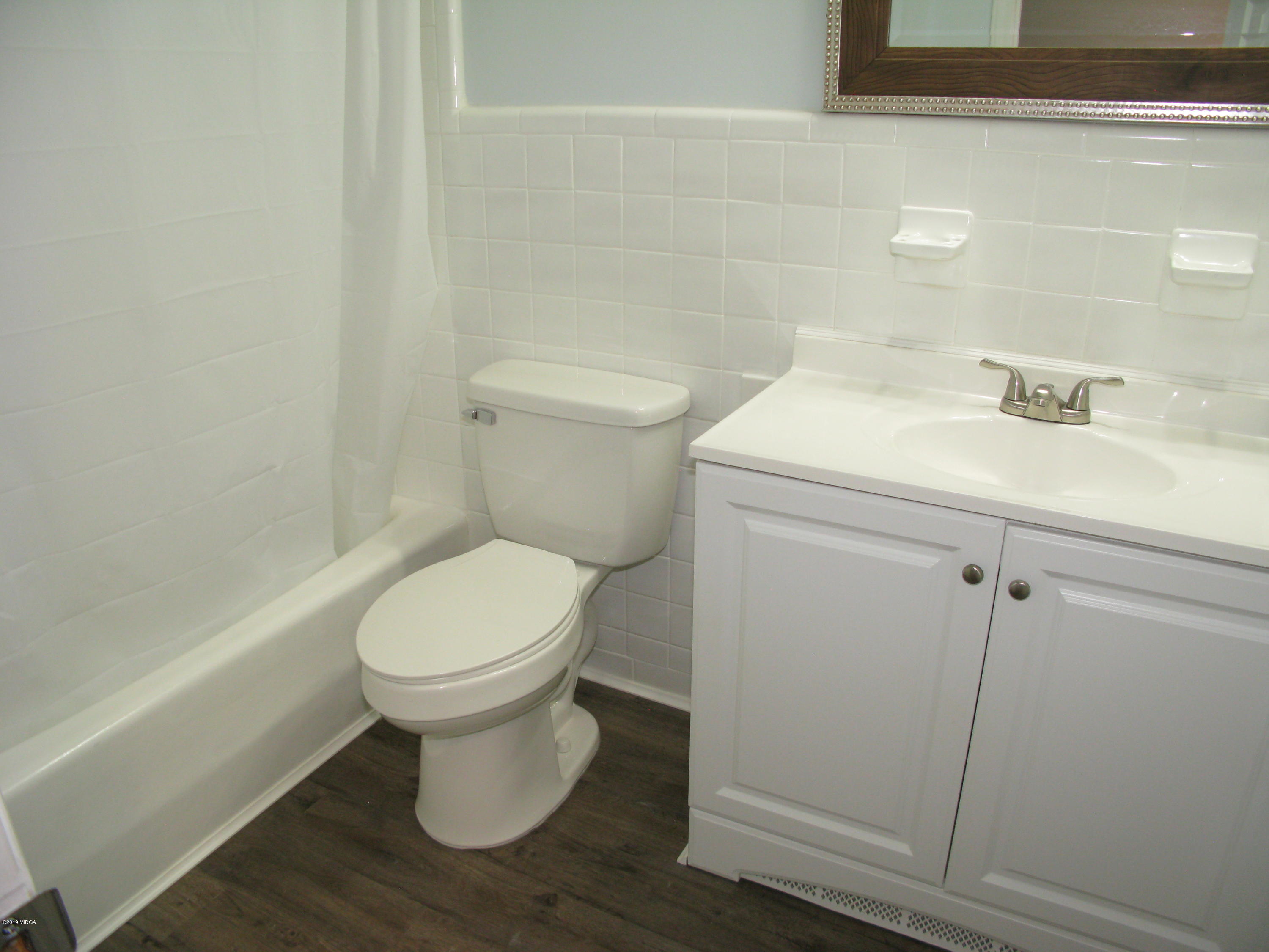 3812 Western Way Macon, GA 31216 - Photo 26 of 29 a bathroom with a toilet sink and mirror