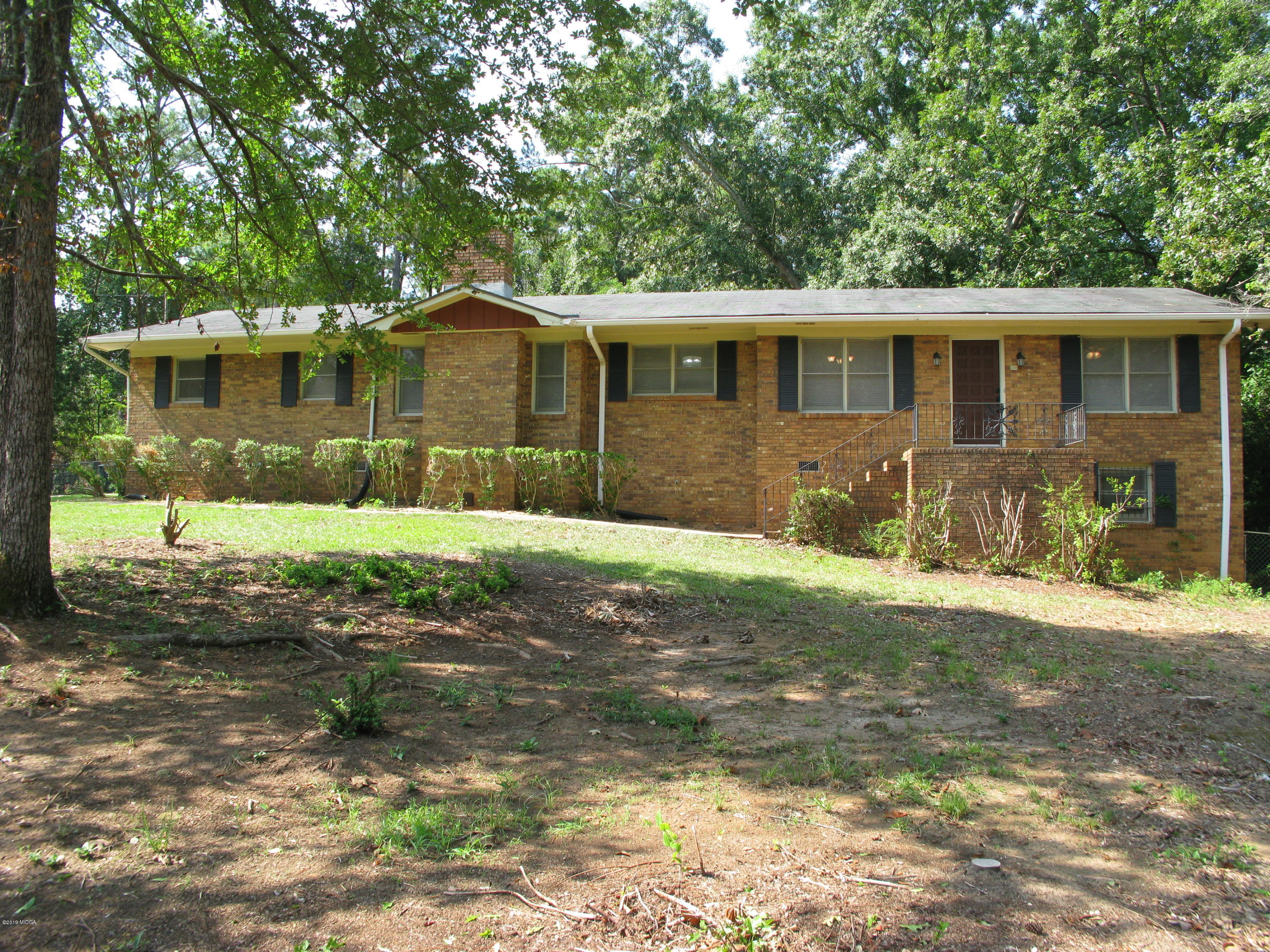 3812 Western Way Macon, GA 31216 - Photo 6 of 29 a front view of a house with a yard and garage