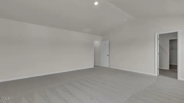 a view of an empty room and closet area
